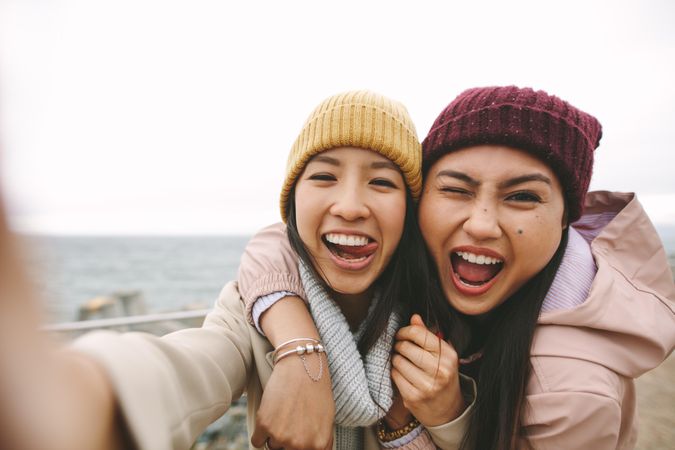 Two young attractive Asian women take silly selfie