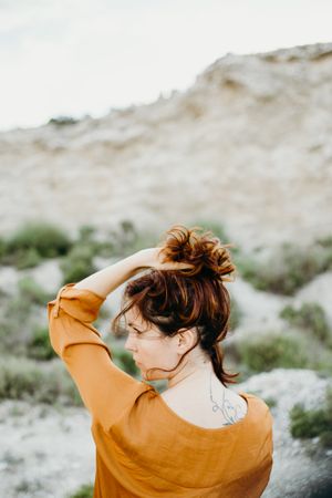 Dreamy attractive young woman posing outdoors