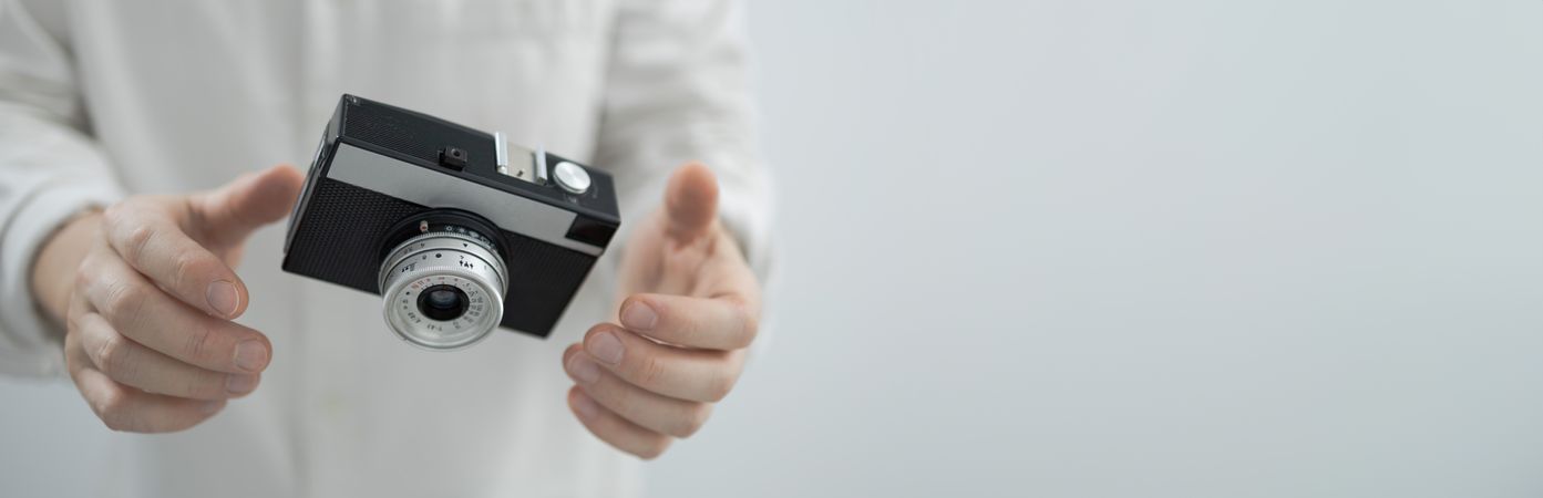 Floating retro camera in hands