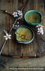 Green tea in cups and blooming peach tree branch garnish 5q6lp4
