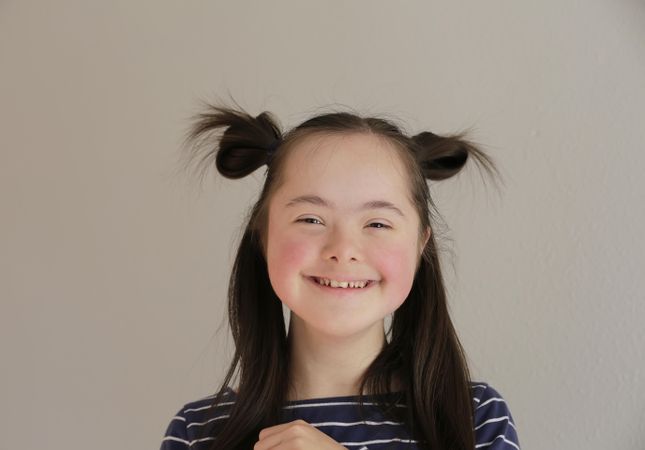 Portrait of happy child with pigtails on her head