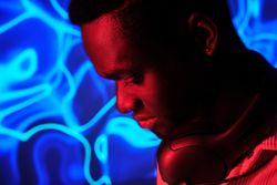 Serious Black man in headphones on neck