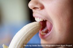 Crop of girl with mouth open eating fresh peeled banana 41ldgD