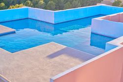 Pool on roof of building with complex geometric shapes