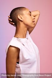 Bald woman standing against colorful background 42qpd5