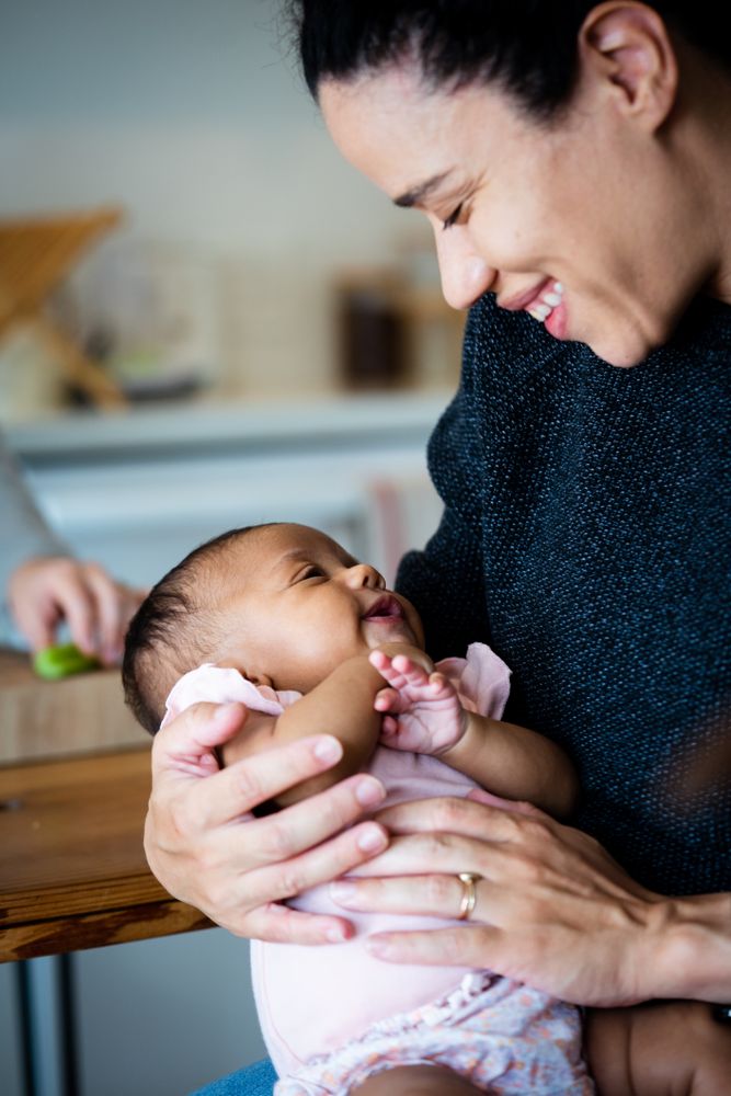 Close up of smiling mother and baby daughter