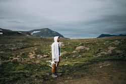 Man holding drone in rocky terrain