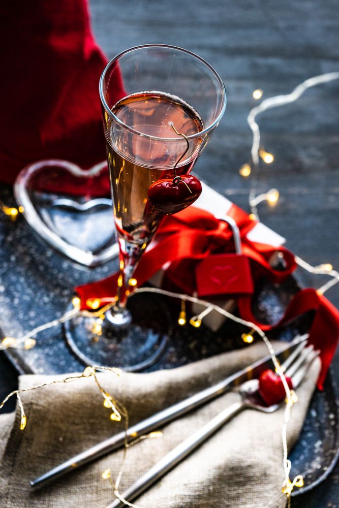 Valentine's day gift box with red lock with champagne and cutlery
