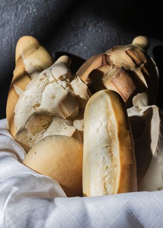 Composition of fresh bread loaves in basket