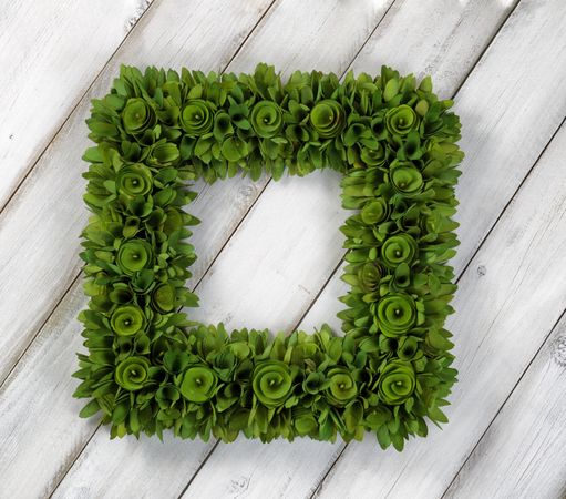 Wreath made with wood chips on rustic wooden boards