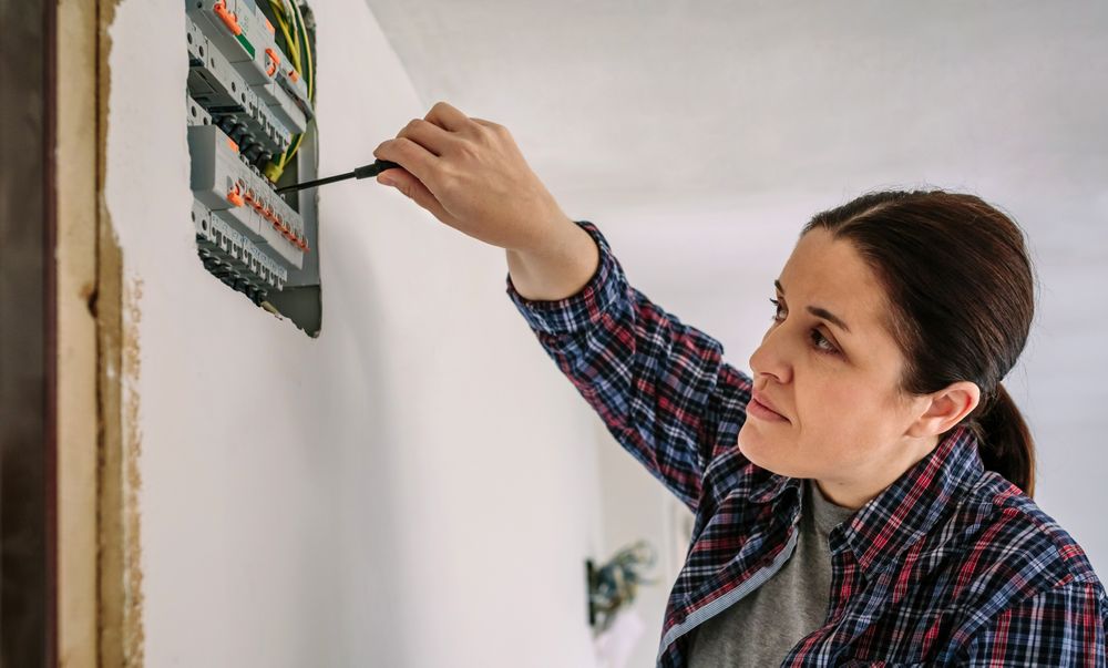 Electrician working on the distribution panel of a house