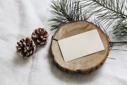 Blank textured business card, invitation mockup on cut wooden round board