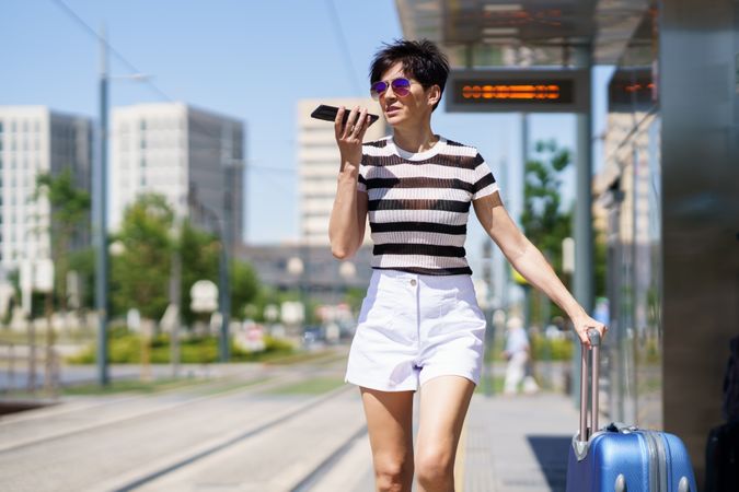 Woman speaking on phone while waiting for train