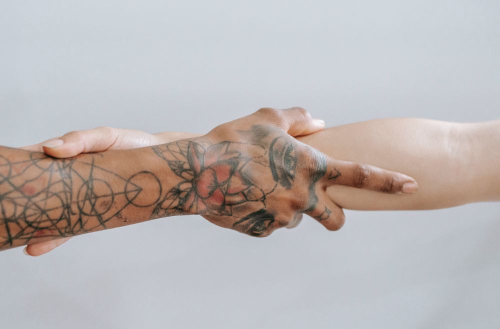 Two hands holding to the elbow