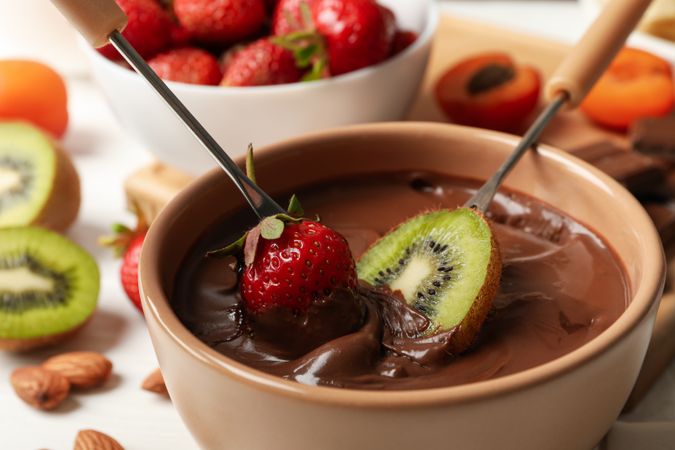 Composition with ingredients for chocolate fondue on wooden background. Cooking fondue