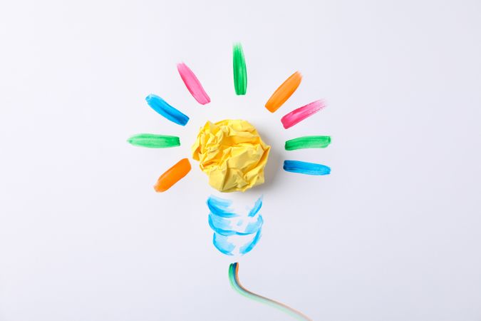 Drawn light bulb and paper ball on blank background, space for text