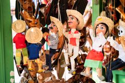 Puppets hanging at market stand for sale