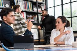 Male and female architect colleagues discussing plans