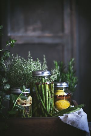 Fresh green vegetables with fruits and glass jars
