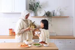 Mom and Kids Preparing ketupat Lebaran for Eid Al Fitr Celebration