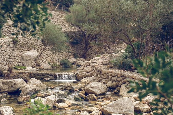 Cascade creek flowing along stones