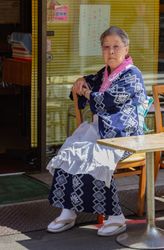 Japan - May, 10 2013: Older Asian woman in outdoor cafe
