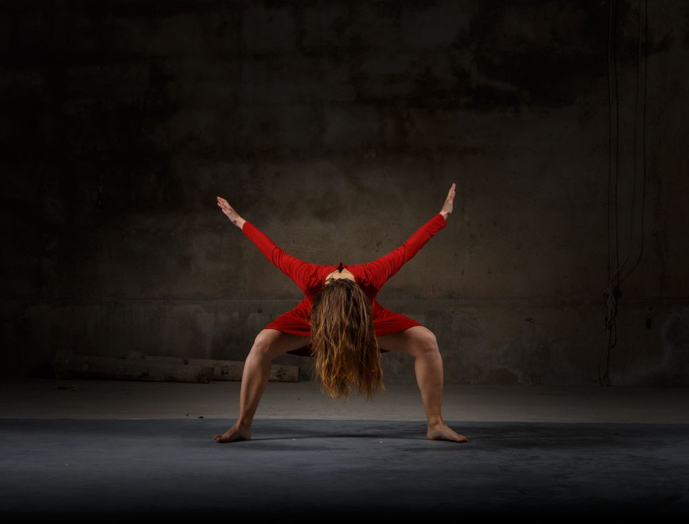 Young woman dancing in darkness