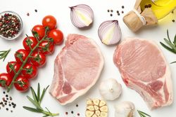 Composition with raw meat and ingredients on light background, top view