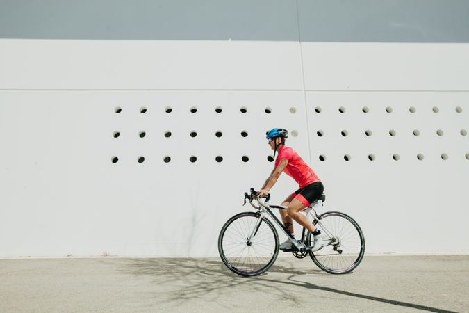Sportswoman riding bicycle on street