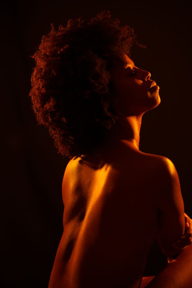 Female with in minimalistic gold studio shot, vertical