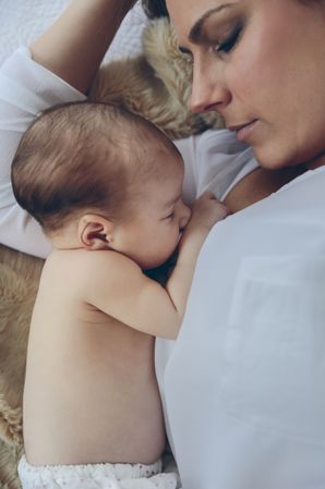 Mother hugging her newborn baby girl