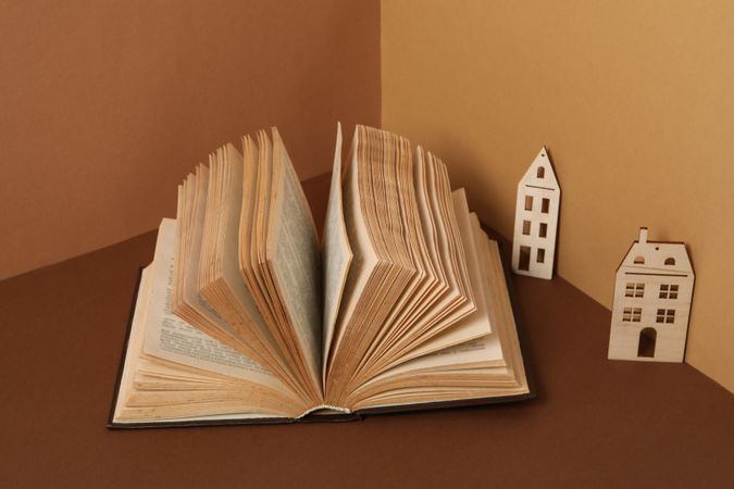 A children's book with toys on a beige background.