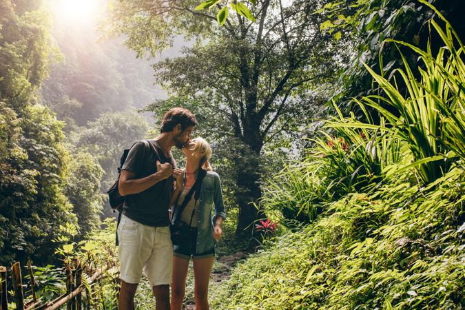 Couple in love kissing while hiking in nature