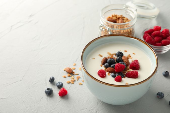 Flat lay composition with parfaits dessert and ingredients on cement background
