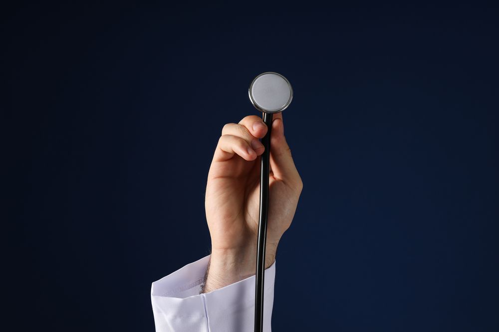 A stethoscope in the hands of a doctor