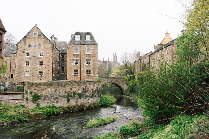 Aged stone buildings with green bushes around