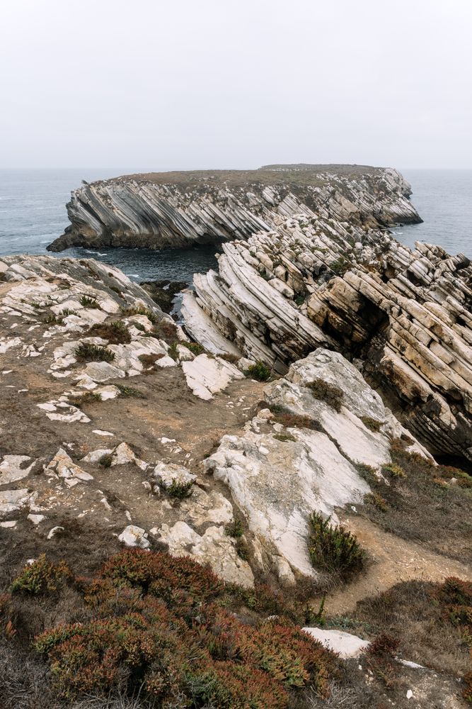 Rocky formations in the island of Baleal on the Atlantic coast in a foggy day. Peniche, Portugal