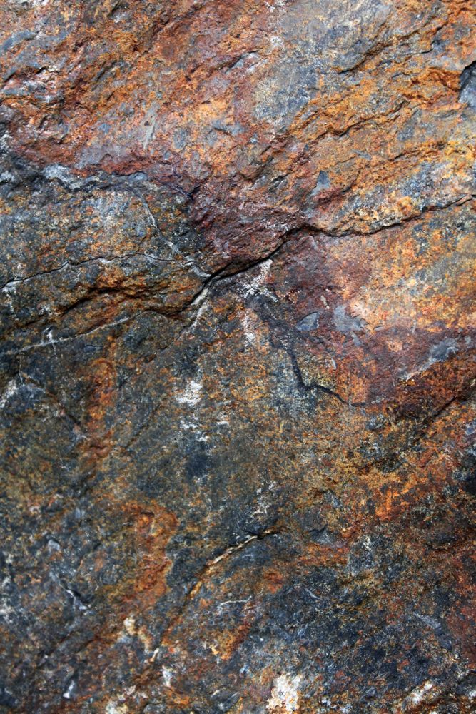 Brown and yellow tones on rock face with burgundy undertones