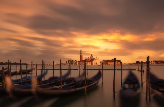 Towers and walls of city under open sky in colors of sunset