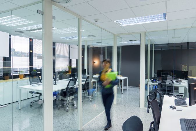 Blurred woman with folders in office