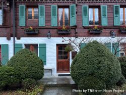 Traditional Swiss chalet in snowy Rougemont, VD with green window shutters 5aX7zG