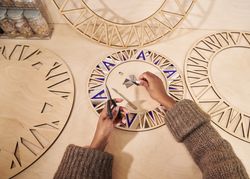 Woman working on decorating a wooden frame