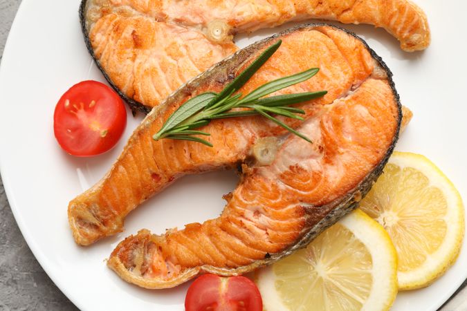 Composition with tasty grilled salmon on gray background, close up