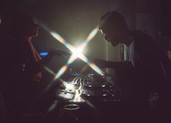 London, England, United Kingdom - Nov 9, 2022: Side view of man DJ-ing with flare