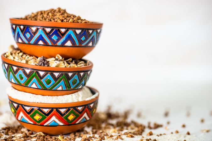 Side view of colorful bowls full of different grains