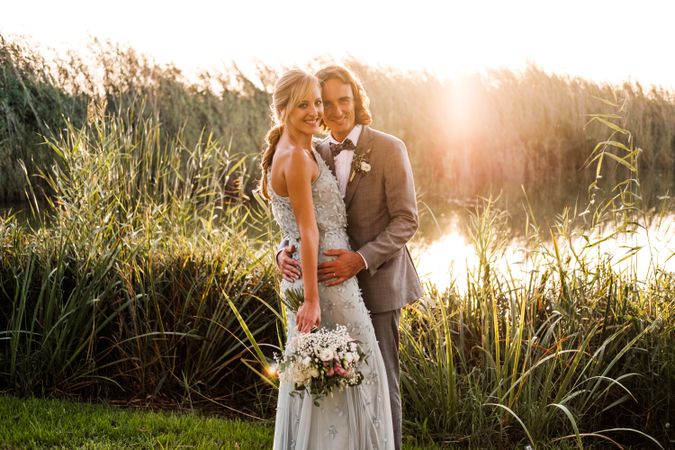 Happy newly wedded couple delighting in event at nature