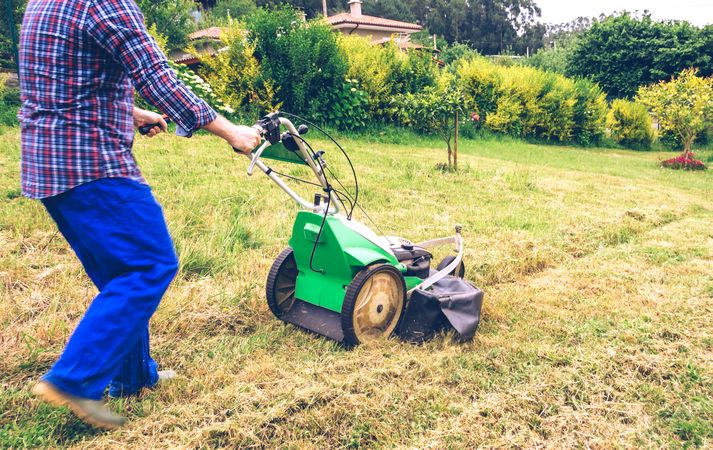 Man mowing the lawn with lawnmower