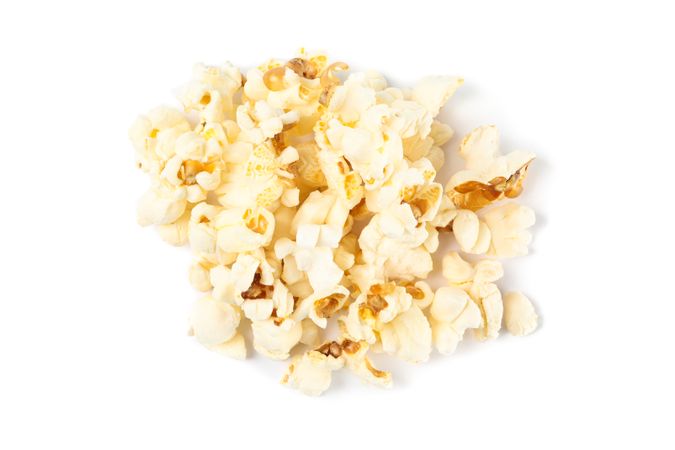 Popcorn pile isolated on blank background, close up