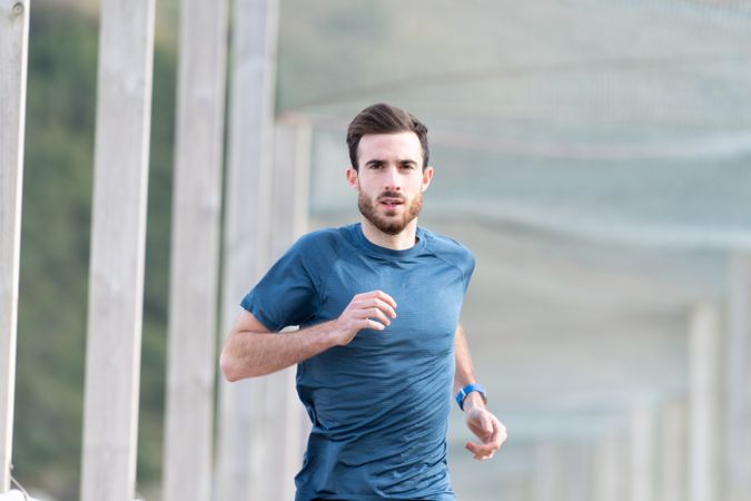 Sportsman jogging outdoors under cover