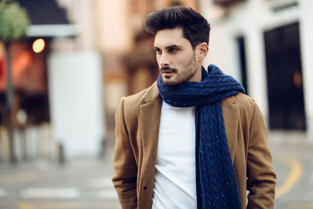 Portrait of man in light winter clothes walking outside